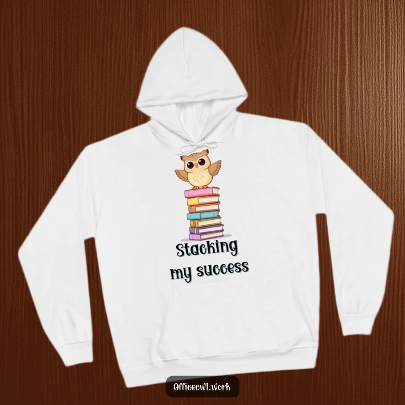 Funny, cozy hoodie featuring a playful owl balancing precariously on a towering, teetering stack of pastel file folders.