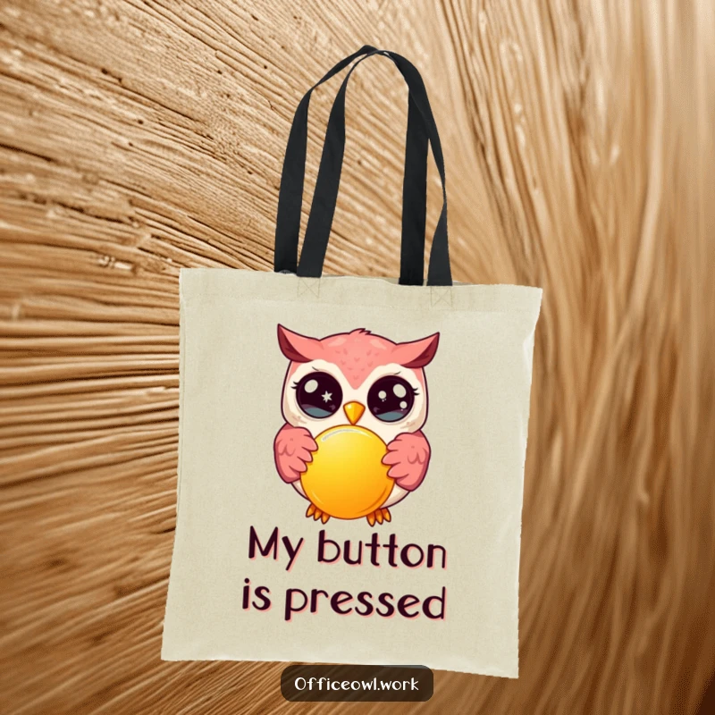Funny kawaii owl with wide, sparkling eyes, enthusiastically pressing a large, bright button on a durable tote bag.